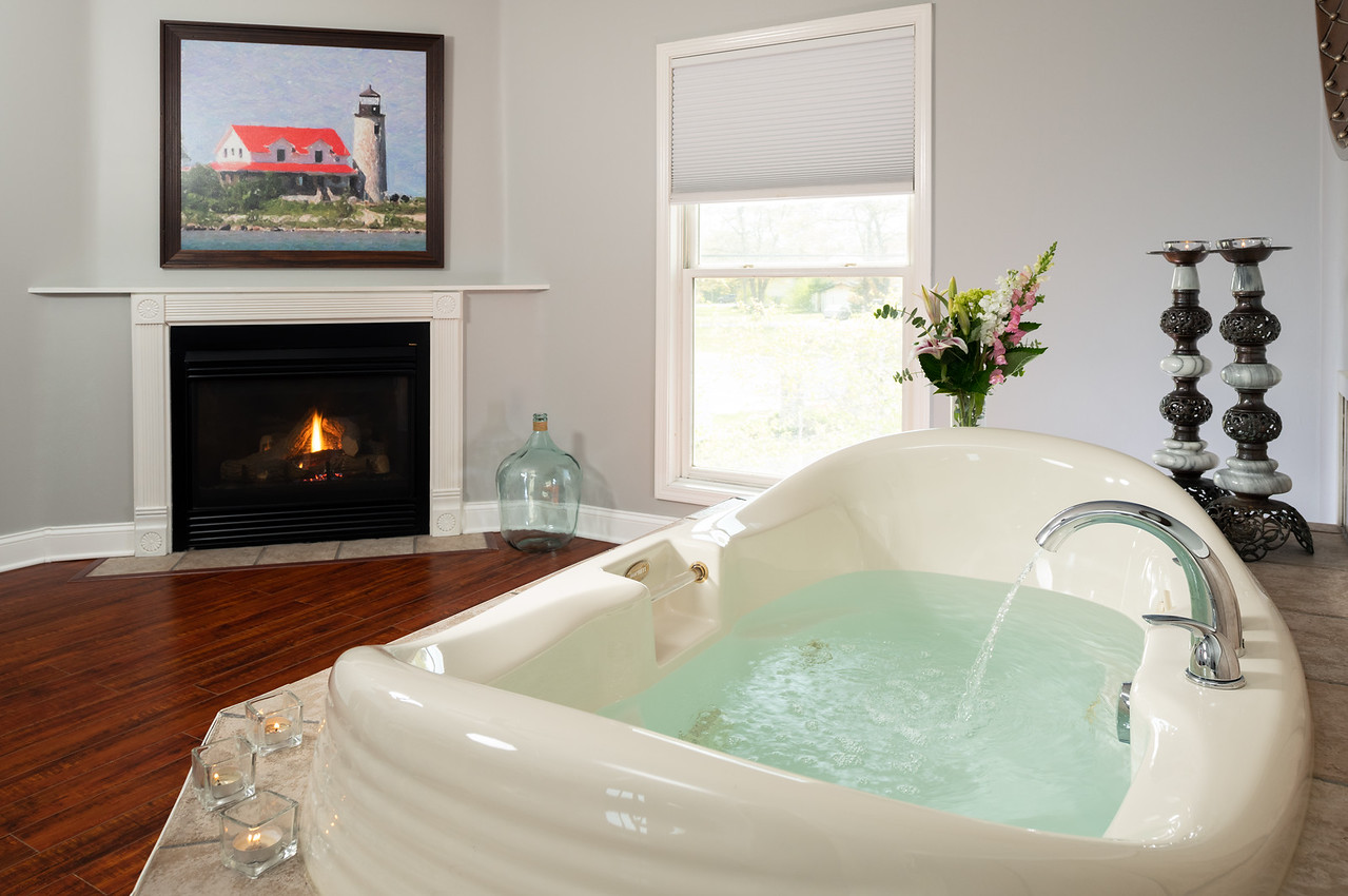 In-room jacuzzi next to gas fireplace